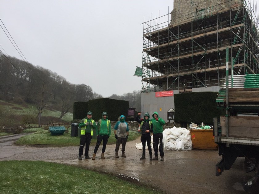 photo of conservation team outside the church in rain